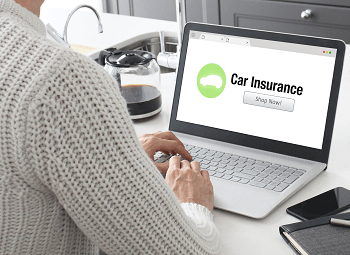 Woman looking for car insurance on a laptop